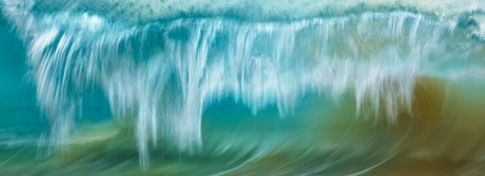 Motion blur of a rolling wave with shades of blue and green; Kihei, Hawaii, United States of America
