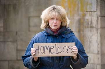 Homeless woman holding a cardboard sign; Undadilla, Nebraska, United States of America