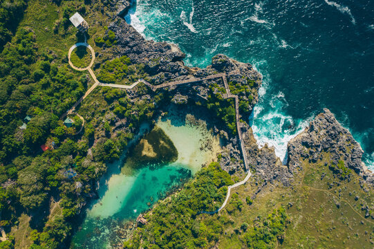 Aerial view of Lake Walakari and trail over the rugged coastline at Nusa Tenggara Timur, Indonesia; Watumbaka, Kecamatan Pandawai, Kabupaten Sumba Timur, Nusa Tenggara Timur, Indonesia