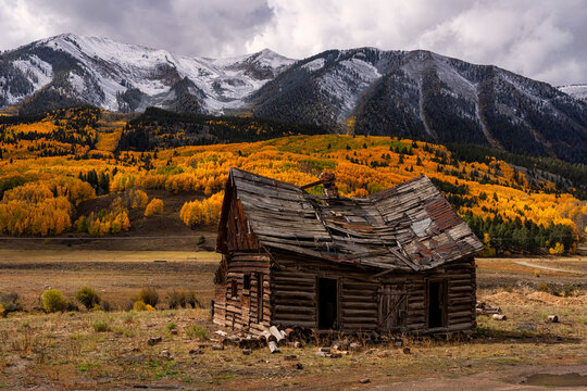 Abandoned cabin crumbling in front of vast autumn beauty in Colorado, USA
