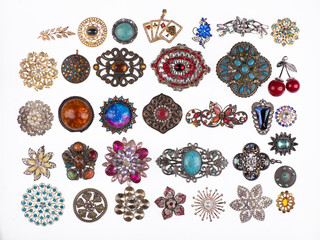 collection of jewelry brooches with precious stones isolated on white background