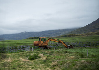 Fototapeta premium yellow excavator in a field in Iceland