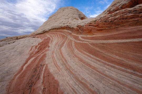 Incredible rock formations in White Pocket, comprised of swirling, multicolured Navajo Limestone with domes, hoodoos and potholes; Arizona, United States of America
