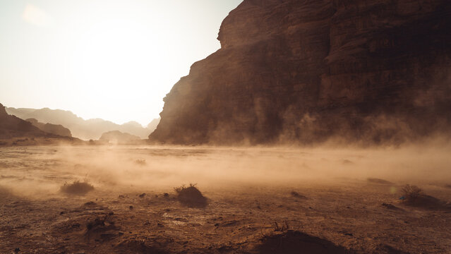 Shifting sands blow along the scorched desert floor