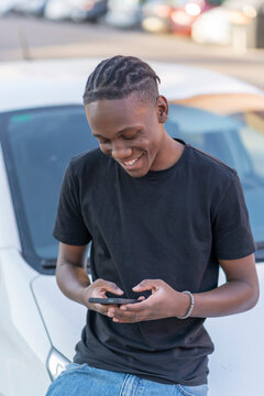 young black man sending a message from his smartphone