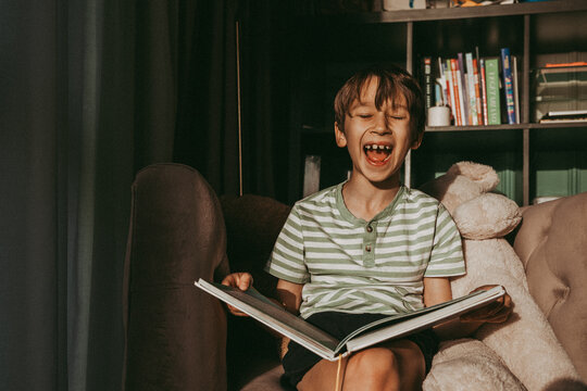 Boy screaming while reading the book in living room