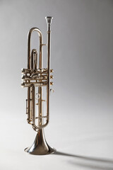 Shiny trumpet on light grey background. Wind musical instrument © New Africa