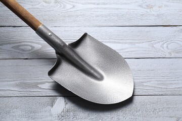 Metal shovel on light grey wooden table
