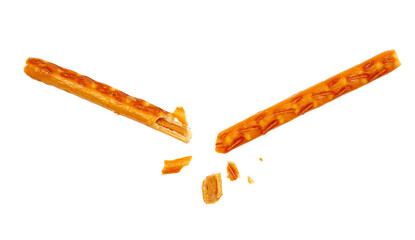 Broken salty cracker pretzel sticks stuffed with peanuts and crumbs isolated on white
