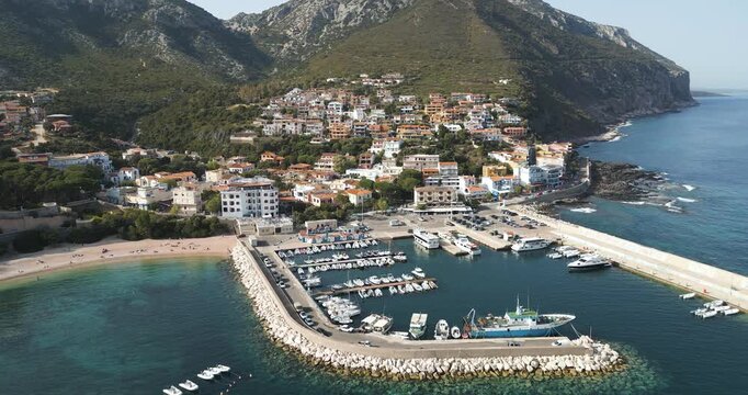 Boats Anchored Near the Shore, With Beachfront Houses in Cala Gonone, Gulf of Orosei, Sardinia, Italy - Aerial Drone Shot