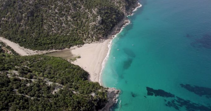 Top Down Aerial Shot Of Turquoise Ocean At Cala Sistine Beach In Sardinia, Italy.
