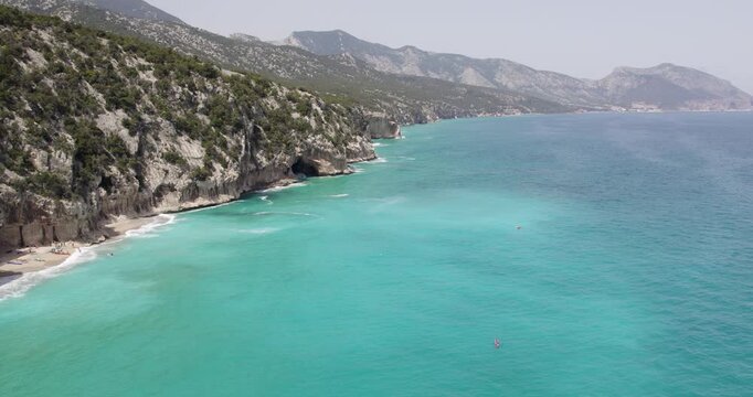 Scenic View Of Gulf Of Orosei With Caves In Cala Gonone, Sardinia, Italy. aerial sideways shot