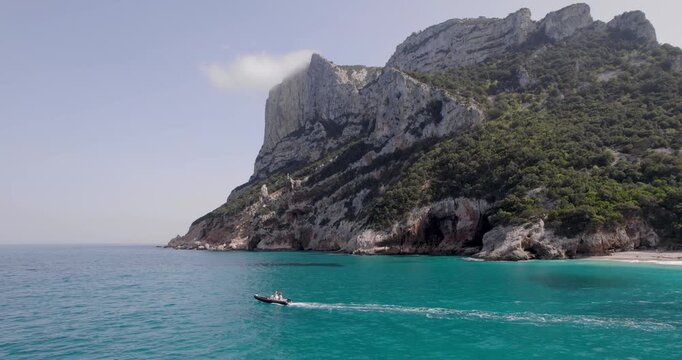 Boat At Cala Sinsine, A Beautiful Beach On The Coastline Of Sardinia. Travel Destination In Italy.