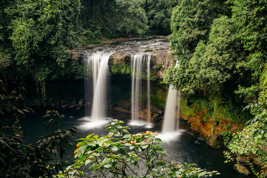 Long exposure of three waterfalls and lush foliage at Tad Champee waterfall along Vang Ngao River in Laos;  Paksong, Laos