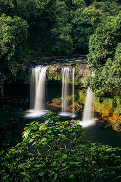 Long exposure of three waterfalls and lush foliage at Tad Champee waterfall along Vang Ngao River in Laos;  Paksong, Laos
