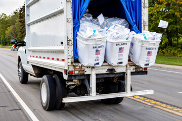 Boxes of voting ballots falling off truck. Fictitious depiction, artist's impression. USA election turmoil, lost ballots, mail