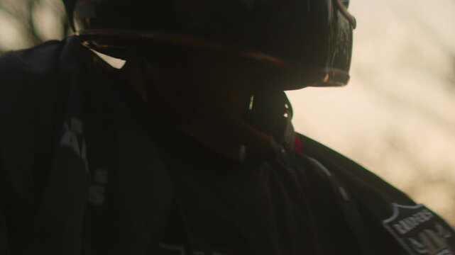 motorcycle rider or biker fasten the protective helmet before start a road trip drive ride 