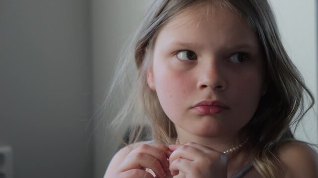 Portrait of Young Girl Observing with Anxious, and Worrisome Expression