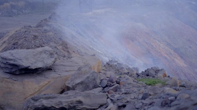 Coal Minery with smoke coming from the underground coal field fire in Jharia, Jharkhand, India