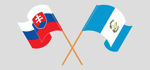 Crossed and waving flags of Slovakia and Republic of Guatemala