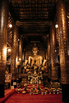 Buddha and altar with ornate design at Wat Xieng Thong, a Buddhist temple in Luang Prabang, Laos; Luang Prabang, Laos