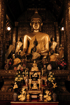 Buddha and altar with ornate design at Wat Xieng Thong, a Buddhist temple in Luang Prabang, Laos; Luang Prabang, Laos