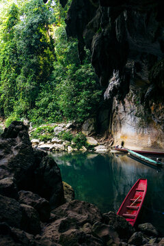 Boats at the entrance of the Kong Lor Cave along the Nam Hin Bun River in Phu Hin Bun National Park; Khammouane Province, Laos