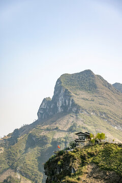 Lone house on a ridge looking out to a mountainous landscape along the Nho Que River in Vietnam; Xin Cai, Meo Vac, Ha Giang, Vietnam