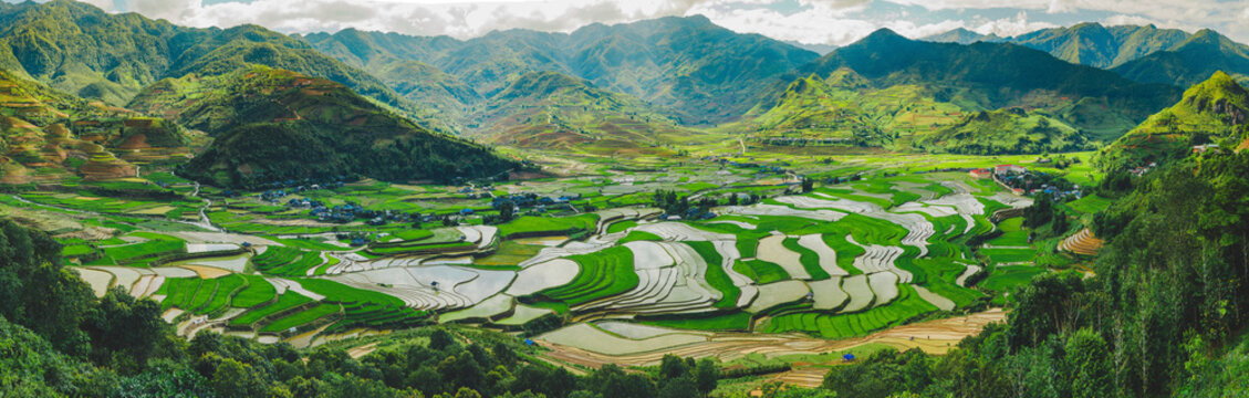 Panoramic view of mountains and terraced farmland in a valley along the Khau Pha Pass in Vietnam; Cao Pha, Mu Cang Chai District, Yen Bai, Vietnam