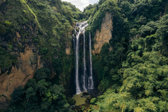 Beautiful waterfalls falling from a lush cliff at Air Terjun Bossolo, South Sulawesi, Indonesia; Jeneponto Regency, South Sulawesi, Indonesia