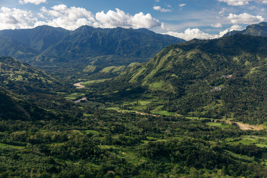 River winding through a lush mountainous landscape with the remote village of Lembah Ollon; Lumbah Ollon, Bonggakaradeng, Tana Toraja Regency, South Sulawesi, Indonesia