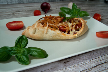Pizza dough boats filled with pasta close up