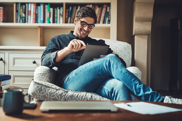 Man, tablet and relax on sofa for social media, communication and reading ebook for work break. Male person, smile and digital tech in home office for online video, chat app and internet connection