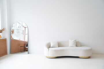 Modern interior in the style of white minimalism. Modern interior design for posters in the living room with a white sofa and with space for copying. High quality photo