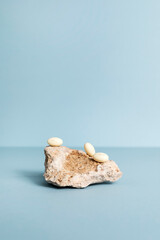 Progesterone Capsules On Stone, Blue Background. Natural Product Concept. Mockup Menopausal Hormone Therapy, Oral Route. Menopause. Cycle Changes. Vertical Copy Space. Design