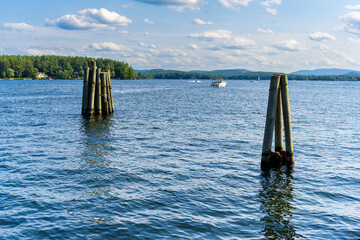 Fototapeta premium Photograph of two wooden pylons in the ocean 