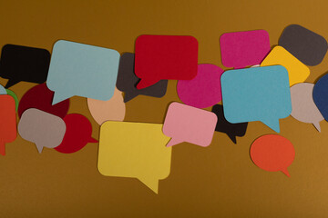 A jumble of colorful speech bubbles on a brown background