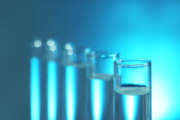 Many glass test tubes on light background, closeup