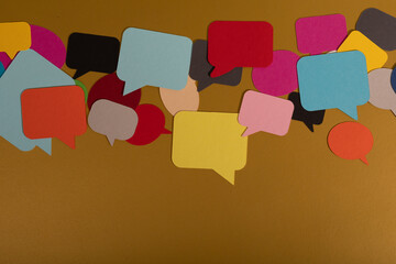 A colorful collection of speech bubbles scattered across a brown surface
