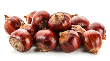 Obraz premium A pile of brown chestnuts on a white background. The chestnuts are shiny and have a smooth surface. They are all about the same size and shape.