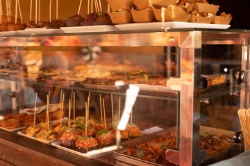 A glass display case filled with various delicious tapas
