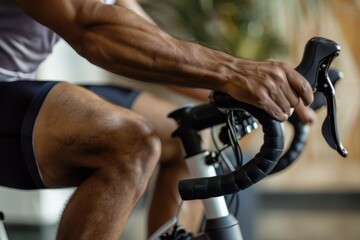 A Close up man using a stationary bike for indoor cycling