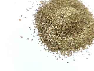 Chopped and dried bay leaves on a bright background.