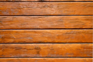 Naklejka premium The texture of wooden boards is painted in brown paint and covered with glossy varnish.