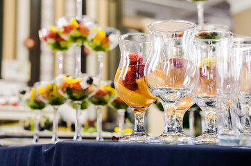 Colorful Fruit Beverages in Glasses. Close-up of vibrant fruit beverages in elegant glasses, arranged on a table, perfect for a festive celebration.