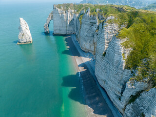 Aerial view of Etretat cliffs and the Atlantic ocean. Chalk cliffs and three natural arches. Panoramic path to admire the coast. Normandy region of Northwestern France. 06-26-2024