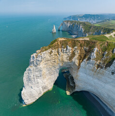 Aerial view of Etretat cliffs and the Atlantic ocean. Chalk cliffs and three natural arches....