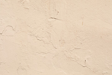 A textured beige wall with subtle cracks