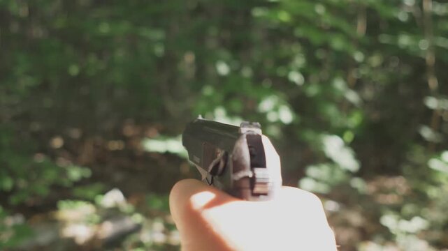 first person view Russian Makarov pistol shooting pneumatic training of Russian soldiers concept in the forest in summer or in an abandoned building