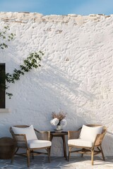 Obraz premium White Wall Patio With Two Wicker Chairs And A Small Table